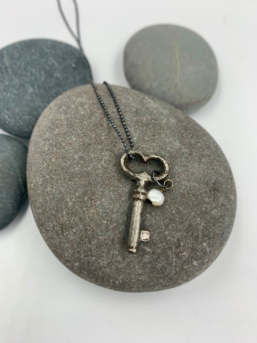 Vintage key pendant with freshwater pearl on a silver chain