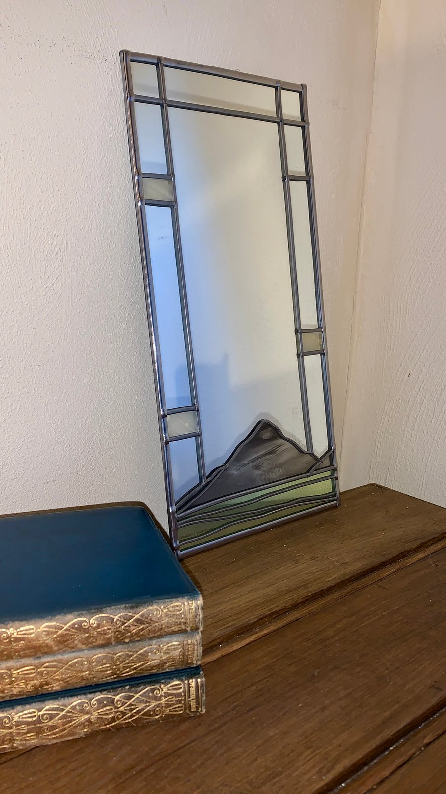 Decorative mirror inspired by the Buachaille Etive Mor mountain .