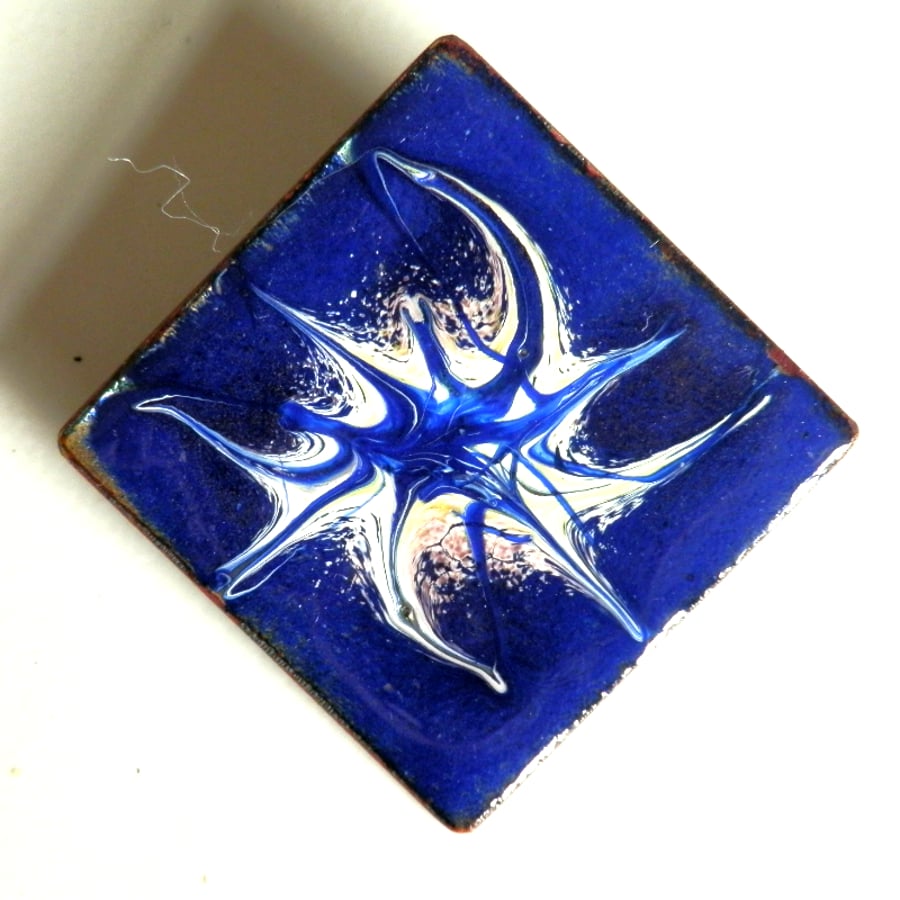 white, yellow, orchid on blue scrolled brooch