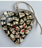 A heart shaped mosaic pendant with a sylised brown and red birds' feet theme.