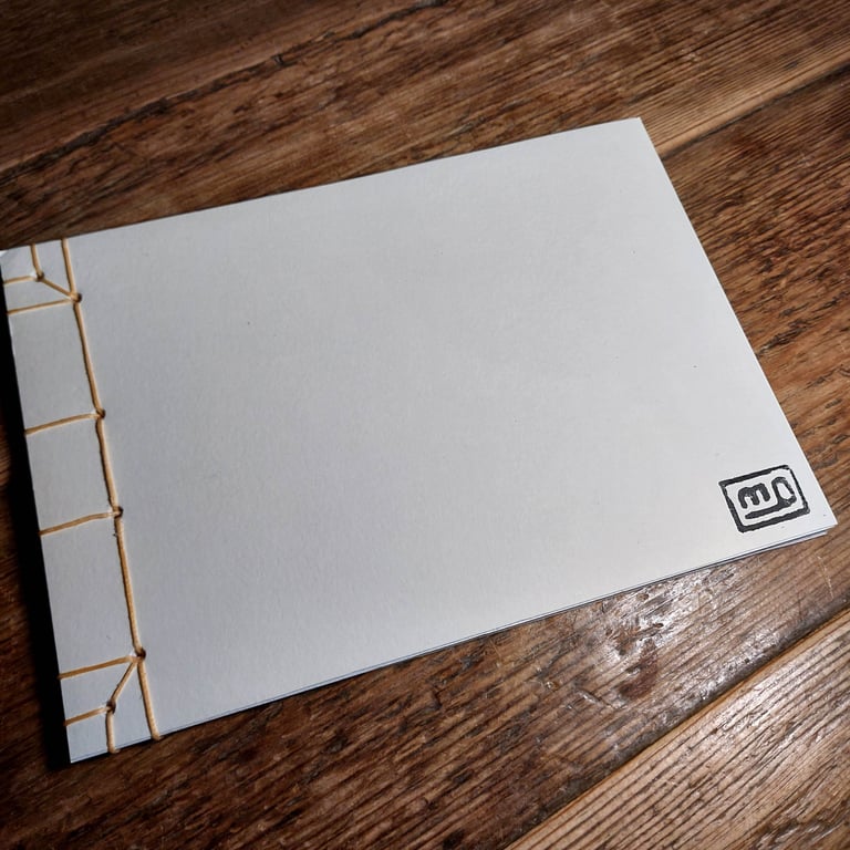 A5 sketch book with chop stamp logo on the front and mono print on the back