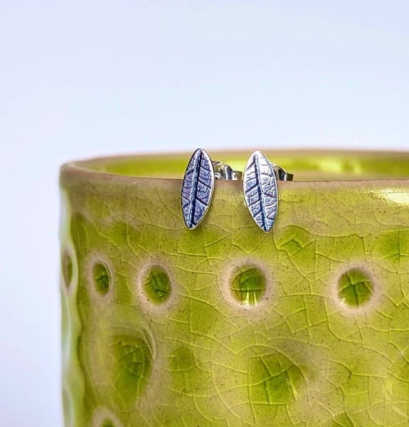 Mini leaf sterling silver stud earrings with leaf printed detail