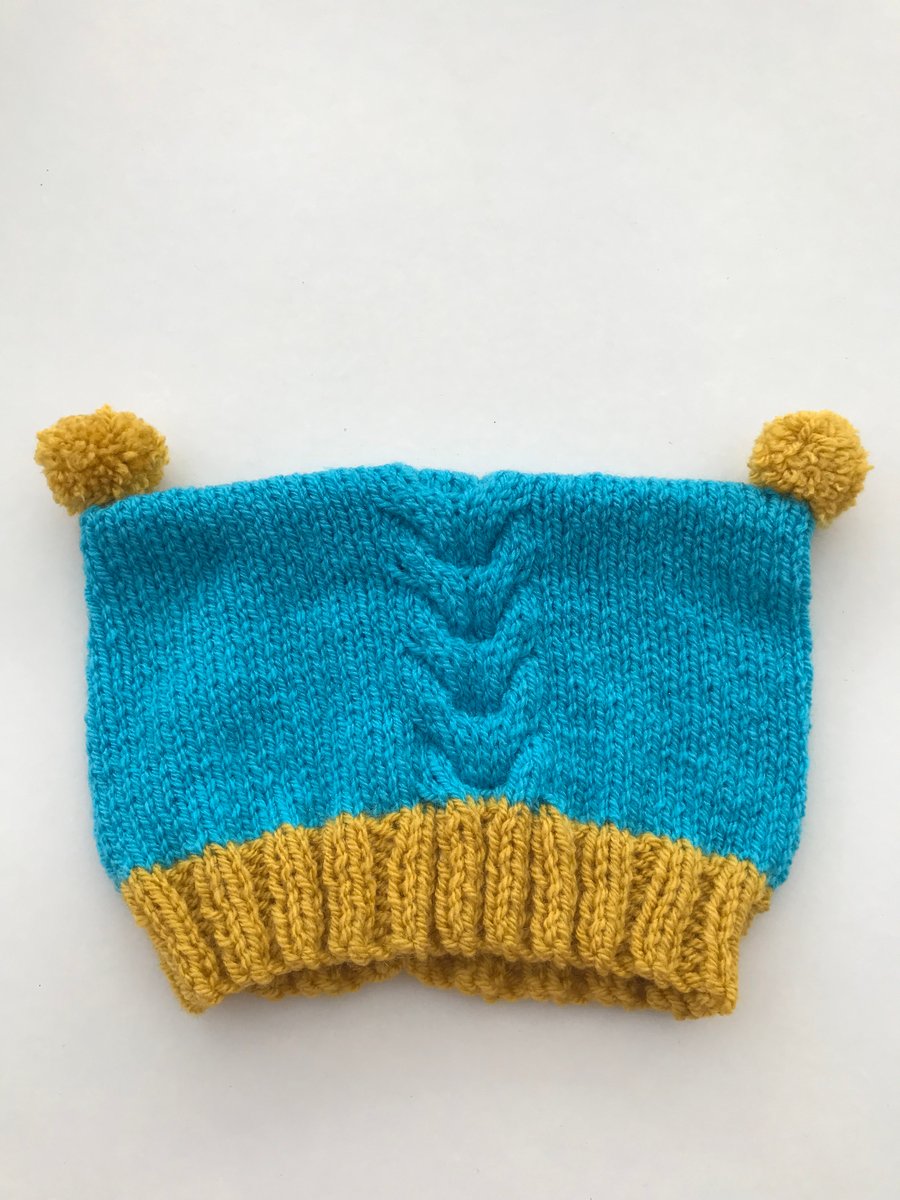 Hand knitted baby hat with pompoms
