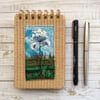 Embroidered wild flower raffia reporters notepad. 