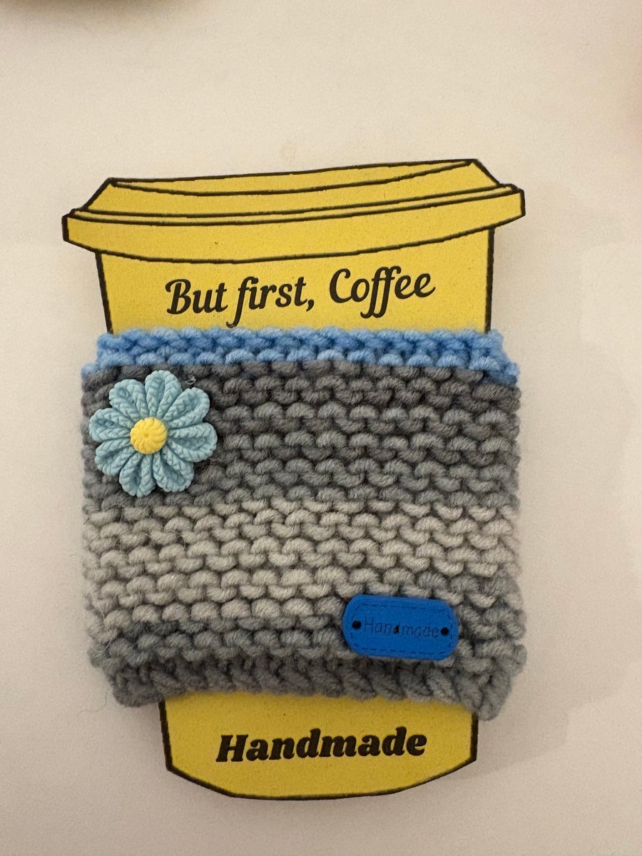 Blue flower knitted cup cosy. 