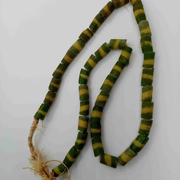39 green powder glass beads with yellow stripe from Ghana