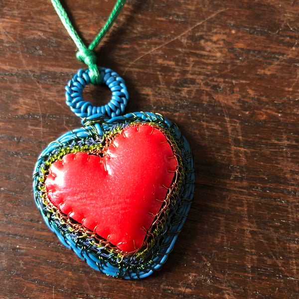 Blue edged red rubber and wire heart pendant from recycled materials