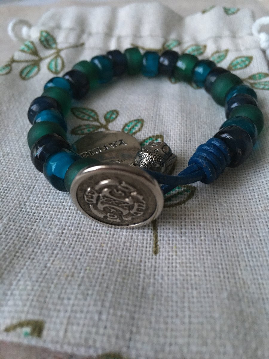 Chunky blue and green glass beads on leather cord.