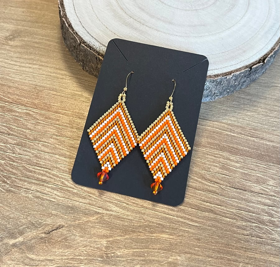 Colourful chevron earrings in orange and gold beadwork with a Swarovski drop 