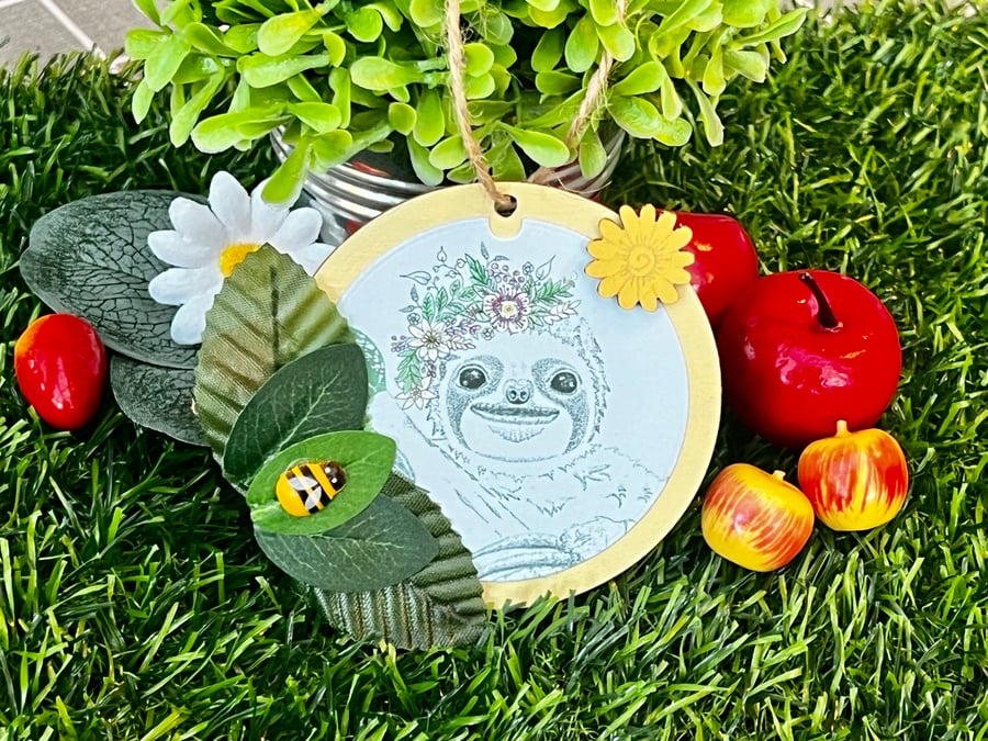 ‘Wooden hanging decoration’ - Artists Illustration of a ‘Smiling Sloth’