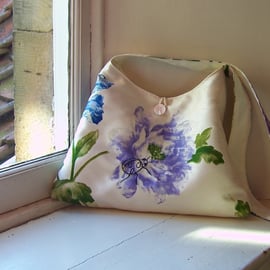 Textile shoulder bag with machine embroidered ladybird design