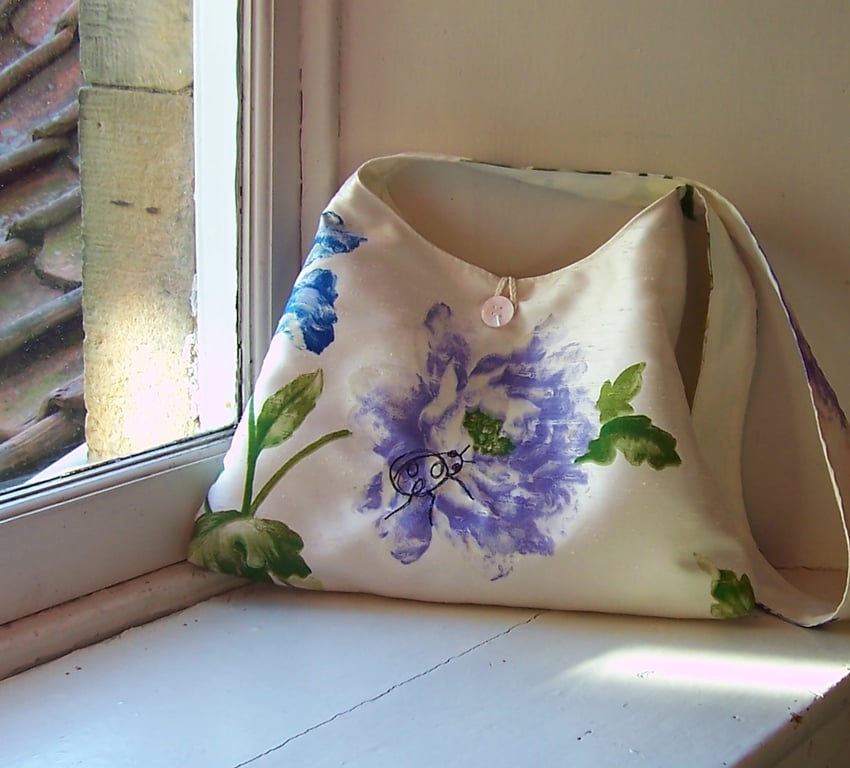 Textile shoulder bag with machine embroidered ladybird design