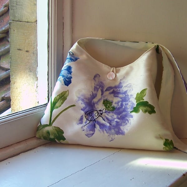 Textile shoulder bag with machine embroidered ladybird design