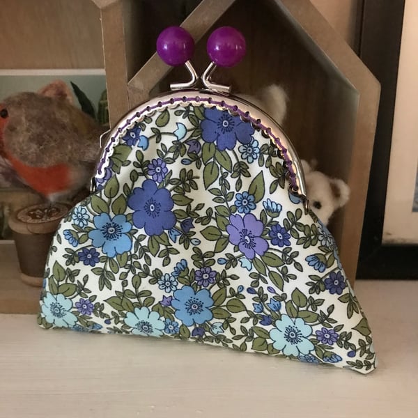 Small coin purse in vintage style fabric and purple ball clasp.