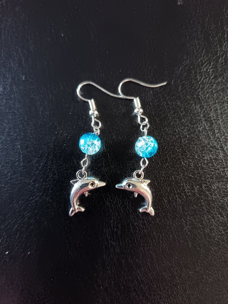 Silver dolphin charm dangle earrings with blue bead detail
