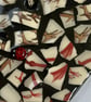 A heart shaped mosaic pendant with a sylised brown and red birds' feet theme. - Image 3