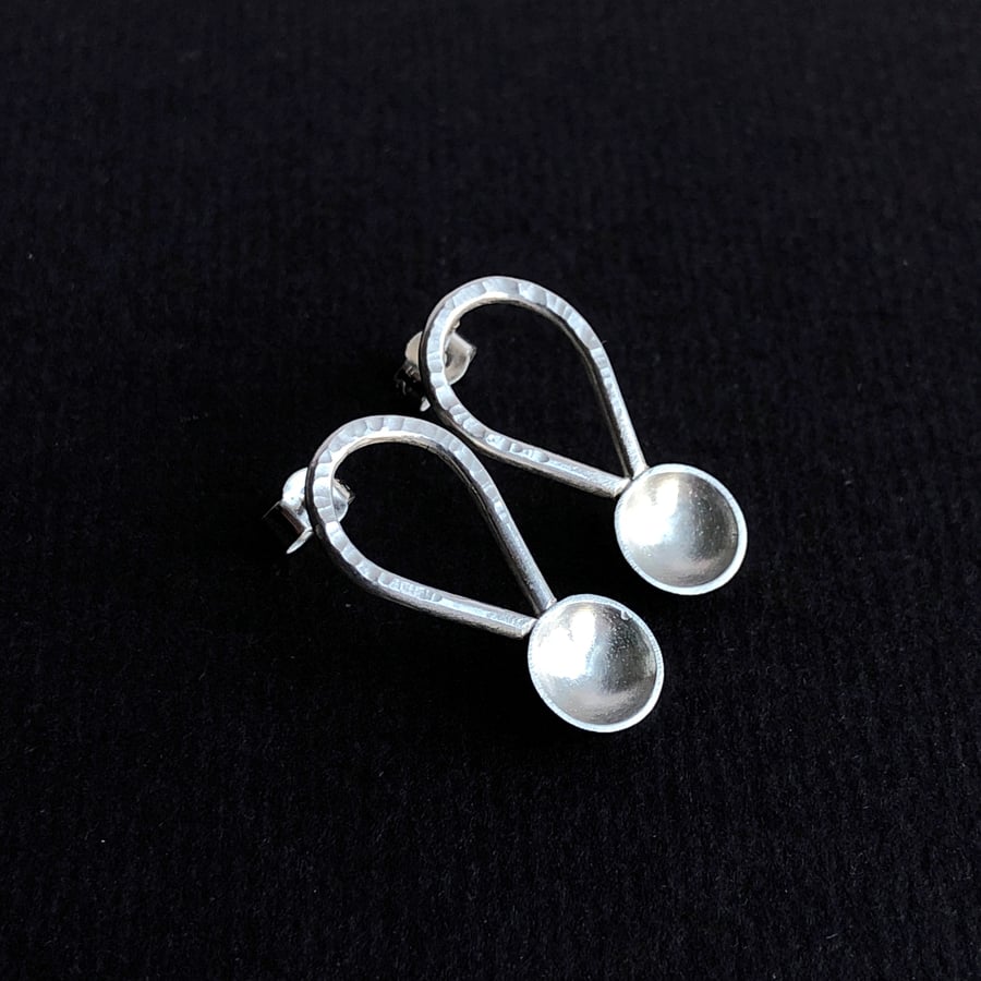 Sterling silver abstract spoon stud earrings with hammered detail.