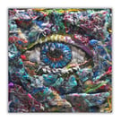 A small framed fibre artwork - needlework - eye - threads - hand stitched