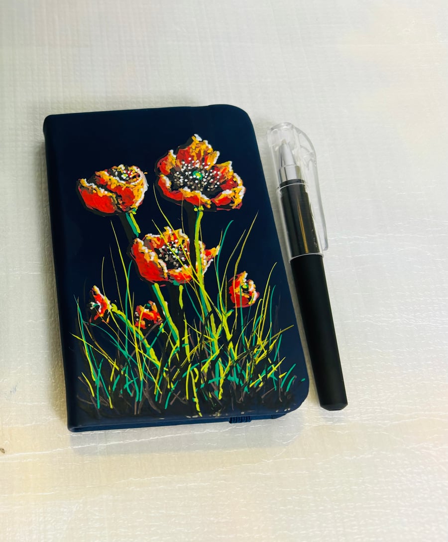 A hand painted and sealed faux leather notebook and pen by Andrew Jenkins