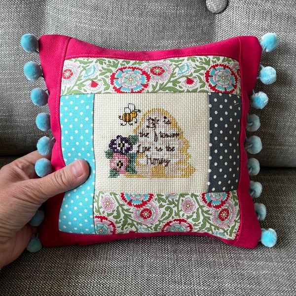 Patchwork mini cushion with bee cross stitch and pompoms 