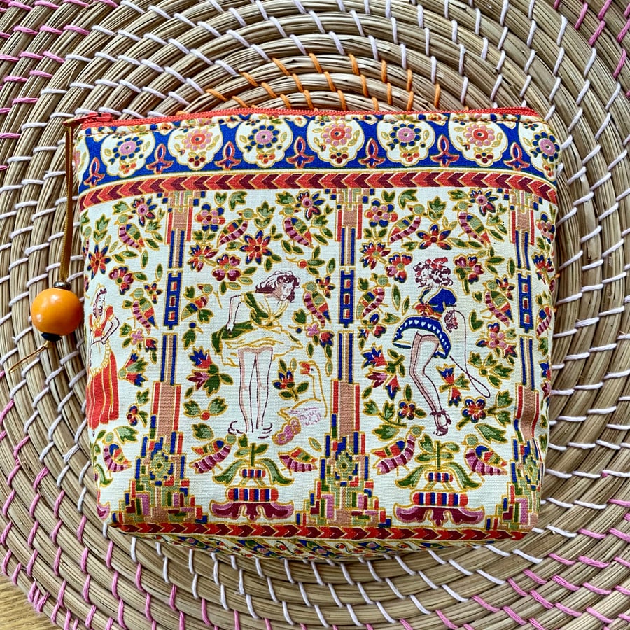 Handmade retro zipped clutch or purse made in vintage style fabric.