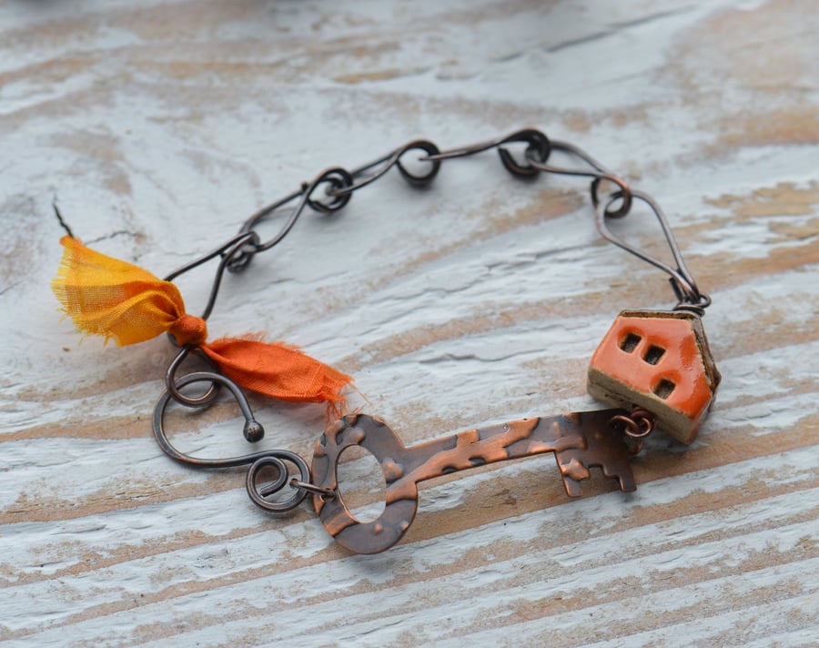 Handmade Copper Bracelet with Embossed Key and Ceramic House Bead