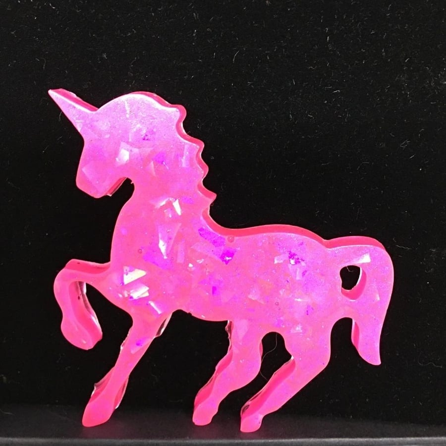Shocking pink unicorn iridescent statement pendant on black cord necklace.