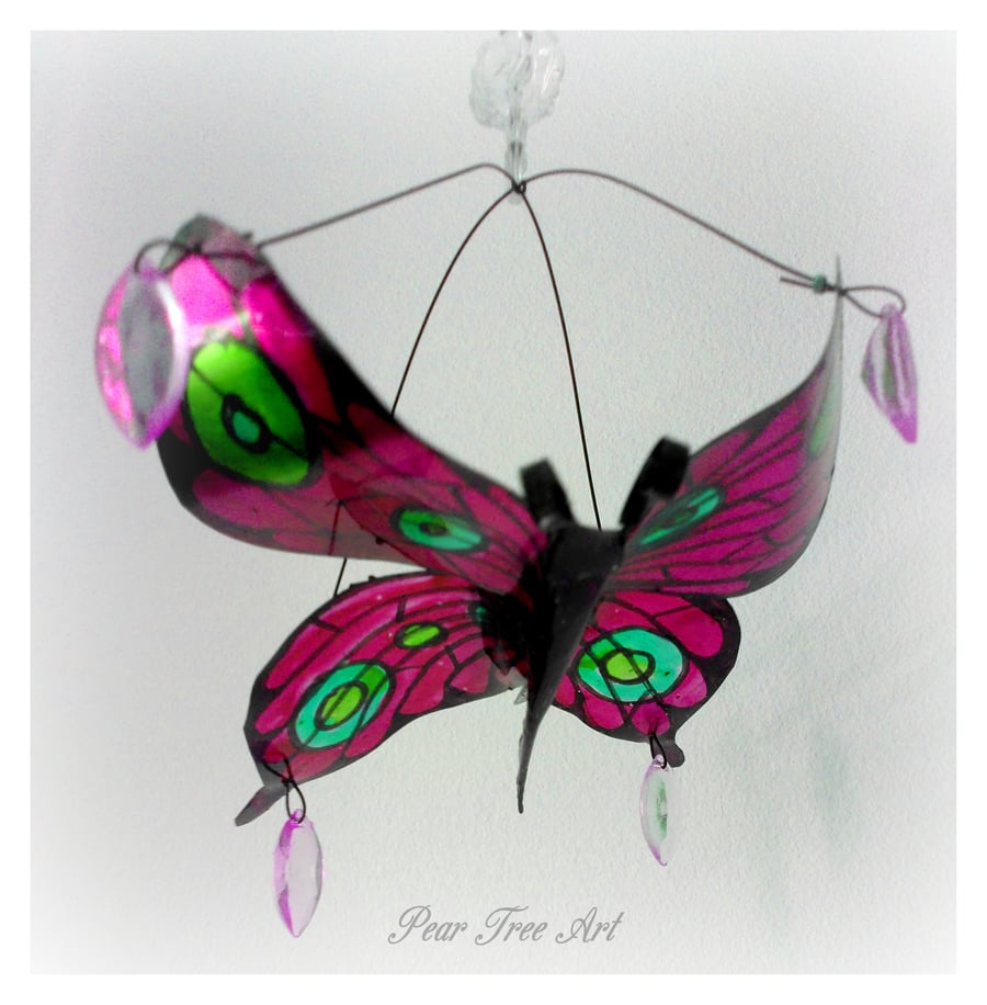 Pink metal butterfly hanging decoration made from a coffee tin. 