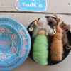 Two baby bodkin brooches in vintage tin