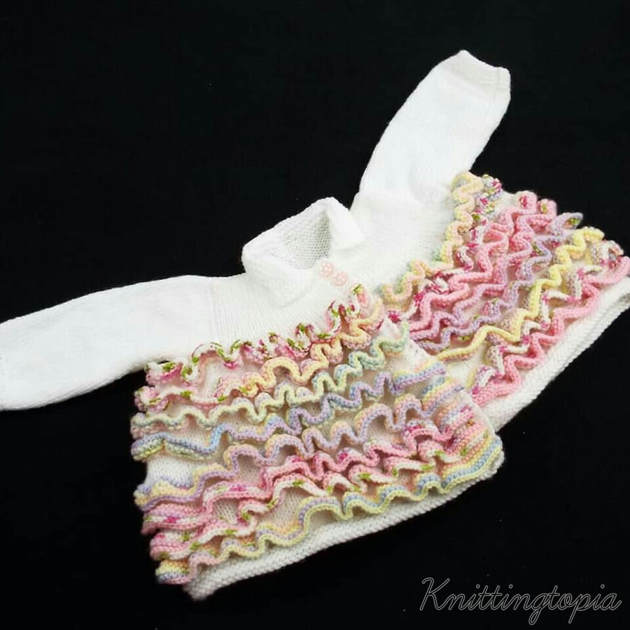 Hand knitted baby cardigan in white with coloured ruffles 0-3 months