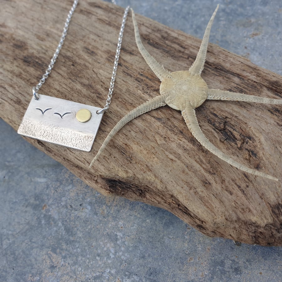 Silver beach, sea coast landscape pendant, with sun and seagulls