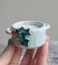 Small ceramic tealight holder with sculpted holly, white glaze