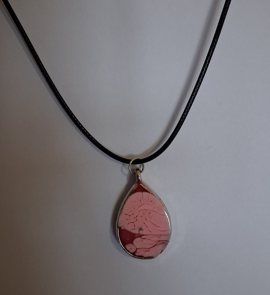 Handmade red pink pendant on black waxed cord
