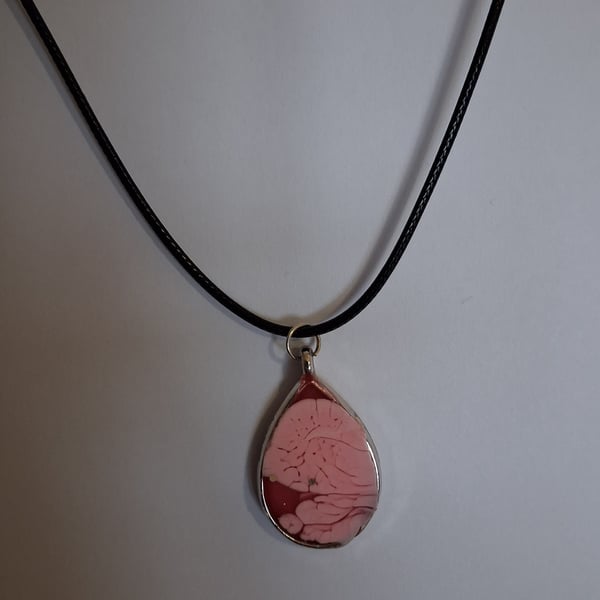 Handmade red pink pendant on black waxed cord