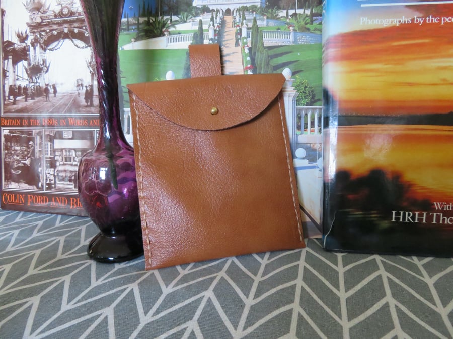 Genuine tan leather belt pouch.