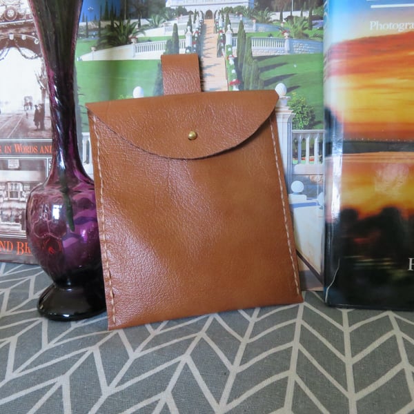 Genuine tan leather belt pouch.