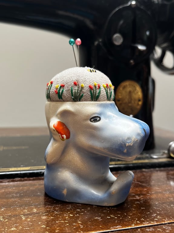 Pin cushion in a vintage hippo egg cup embroidered flowers and bee