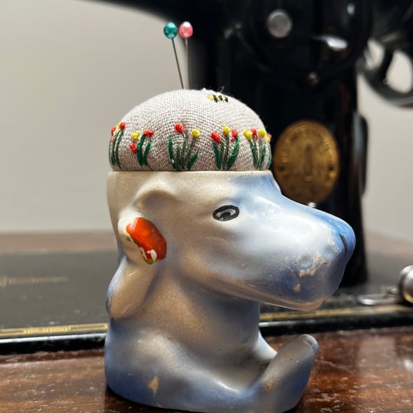 Pin cushion in a vintage hippo egg cup embroidered flowers and bee