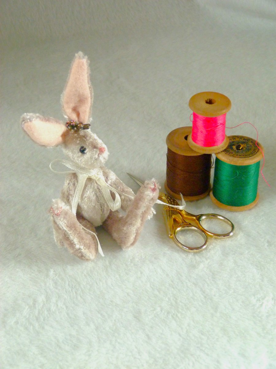 Pearl, a miniature collectable rabbit sitting on a nasturtium leaf.