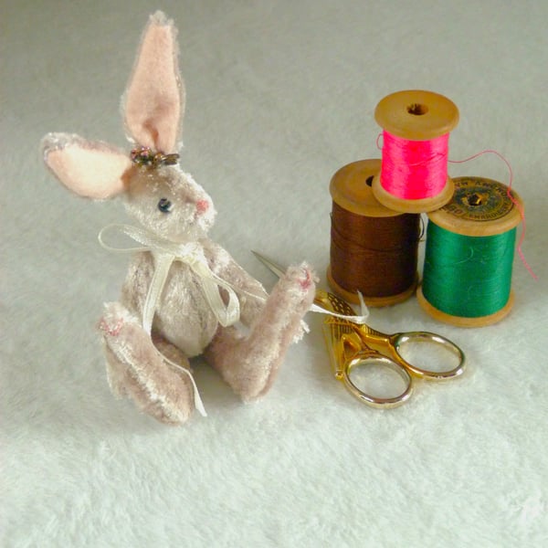 Pearl, a miniature collectable rabbit sitting on a nasturtium leaf.