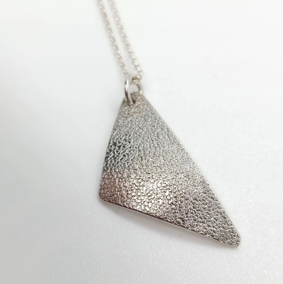 Andama High Shine off set triangle pendant with texture sterling silver