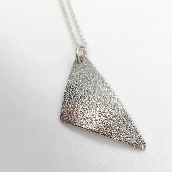 High Shine off set triangle pendant with texture sterling silver