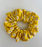 Cotton scrunchie hair accessory in a yellow and white fun print