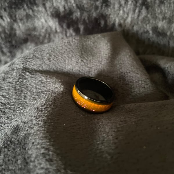 Resin ring with pink glitter and light orange base 
