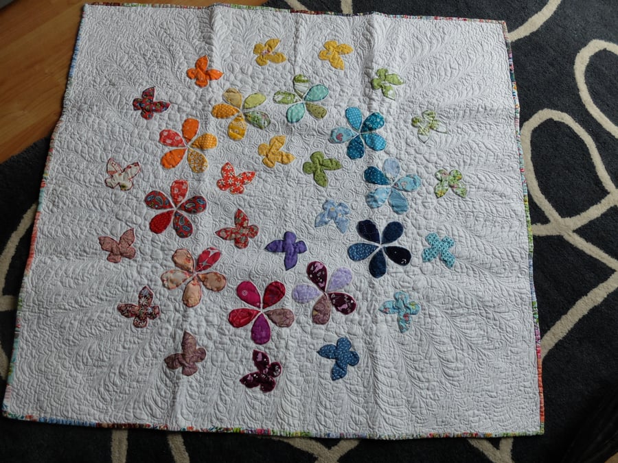Hand made nursery quilt, applique flowers and butterflies in rainbow colours. 