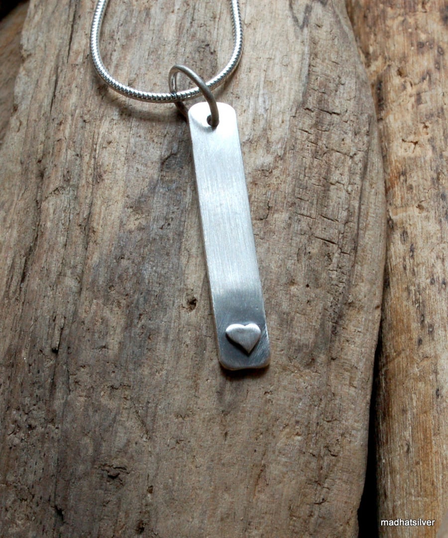 Silver bar pendant with heart decoration
