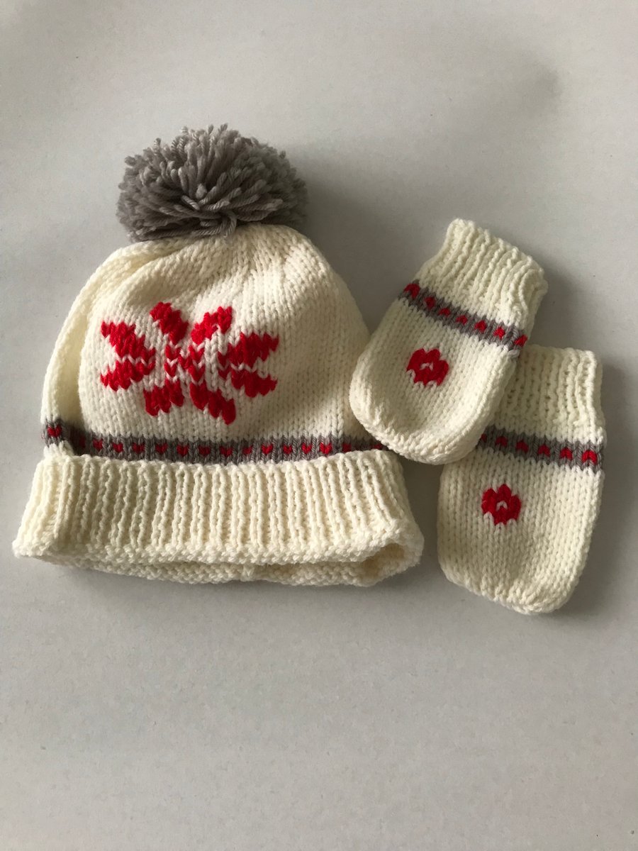 Hand knitted baby pompom hat and mittens with snowflake design