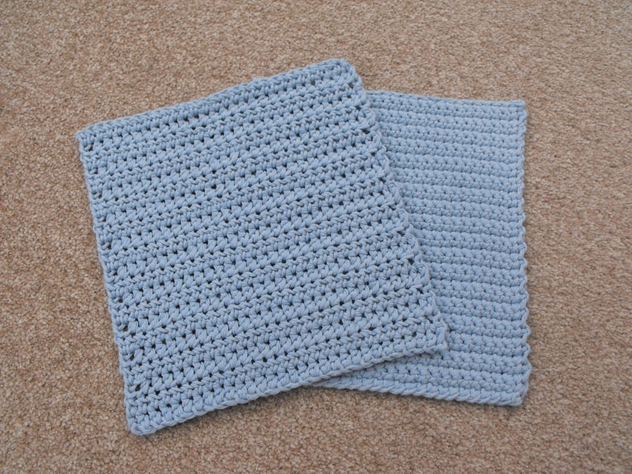 Set of two crocheted dishcloths made from a light blue recycled denim yarn