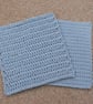 Set of two crocheted dishcloths made from a light blue recycled denim yarn