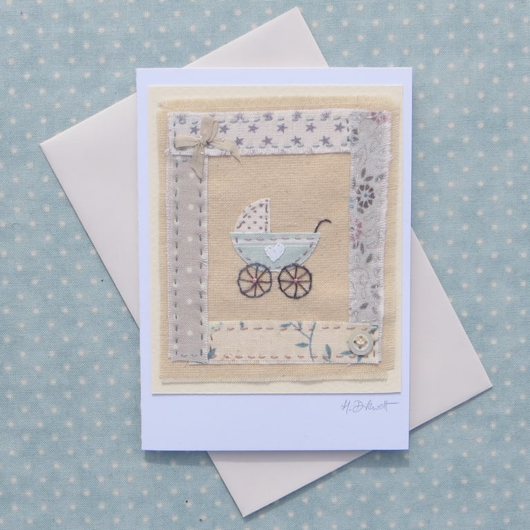 Little pram embroidered card to welcome a new baby, silk bow and mop button